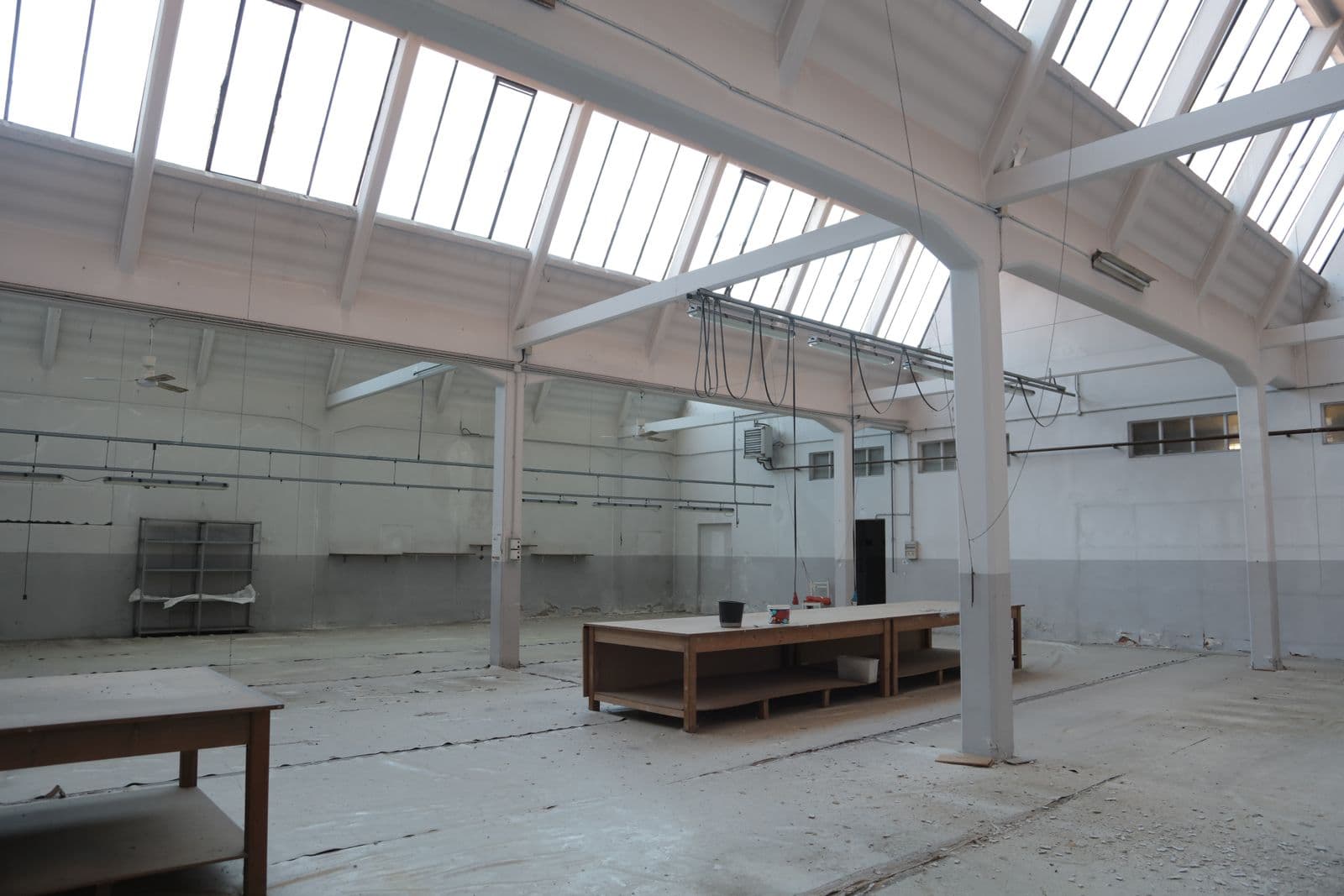 Industrial facility interior with exposed structural and electrical systems